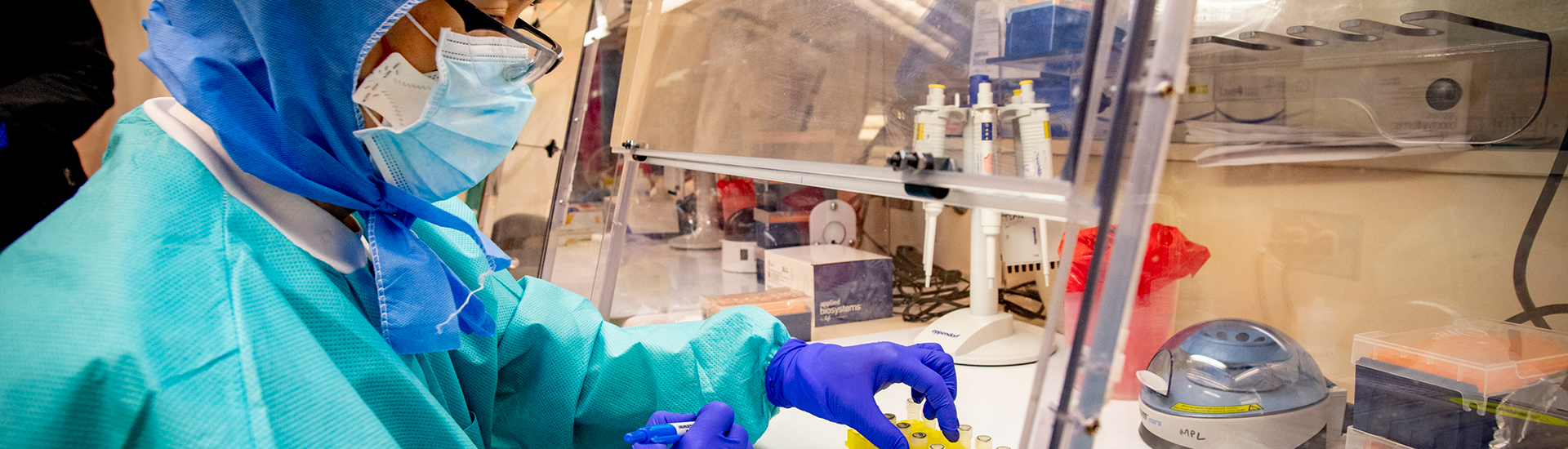 A Tulane researcher works on an experiment in a lab