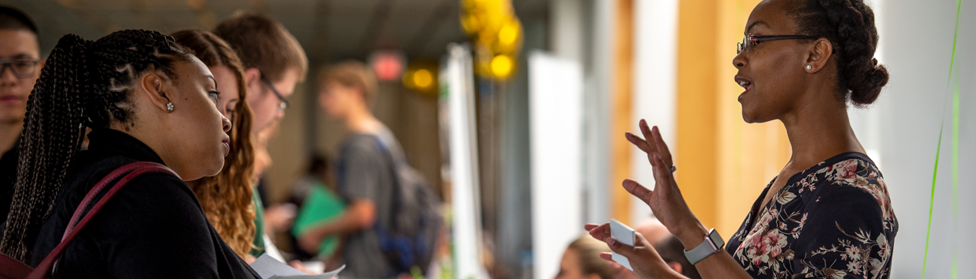 A Tulane staffer talks to a student about working for Tulane