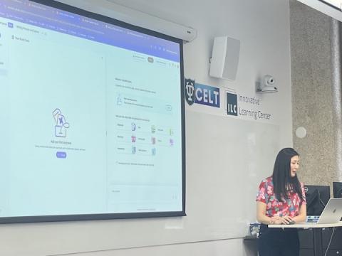Woman presenting next to a large screen displaying software, "CELT" logo on whiteboard.