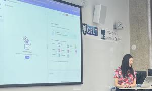 Woman presenting next to a large screen displaying software, "CELT" logo on whiteboard.
